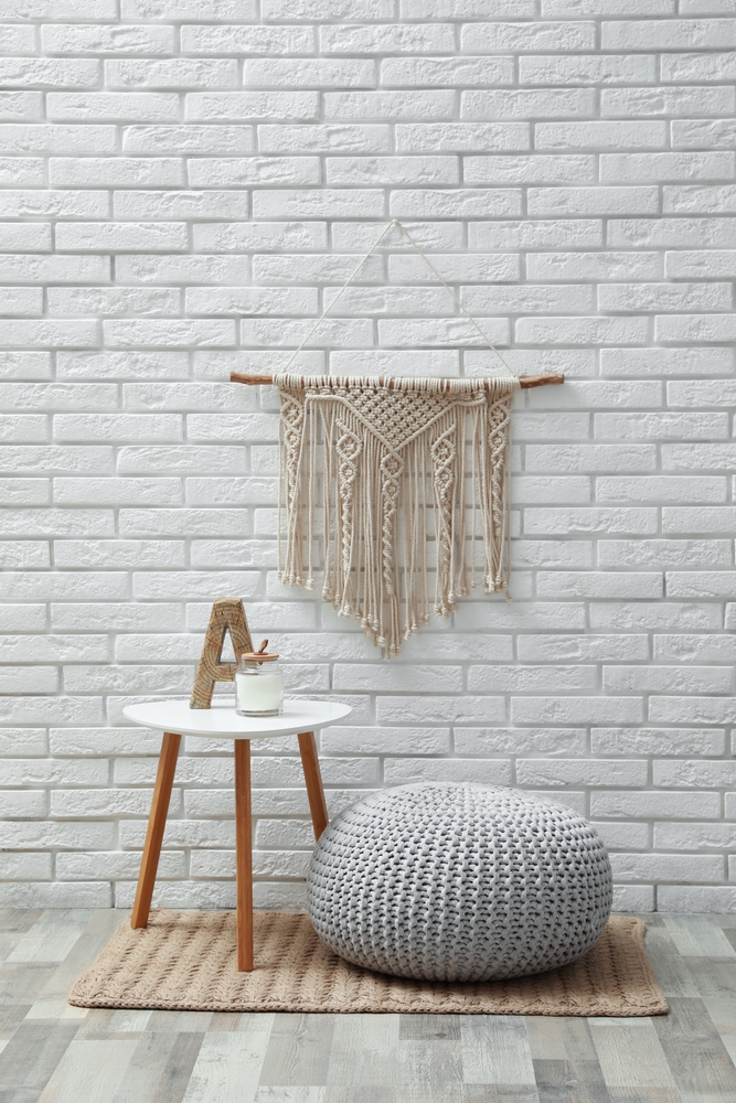 Comfortable,Knitted,Pouf,,Table,And,Decor,Elements,Near,White,Brick
