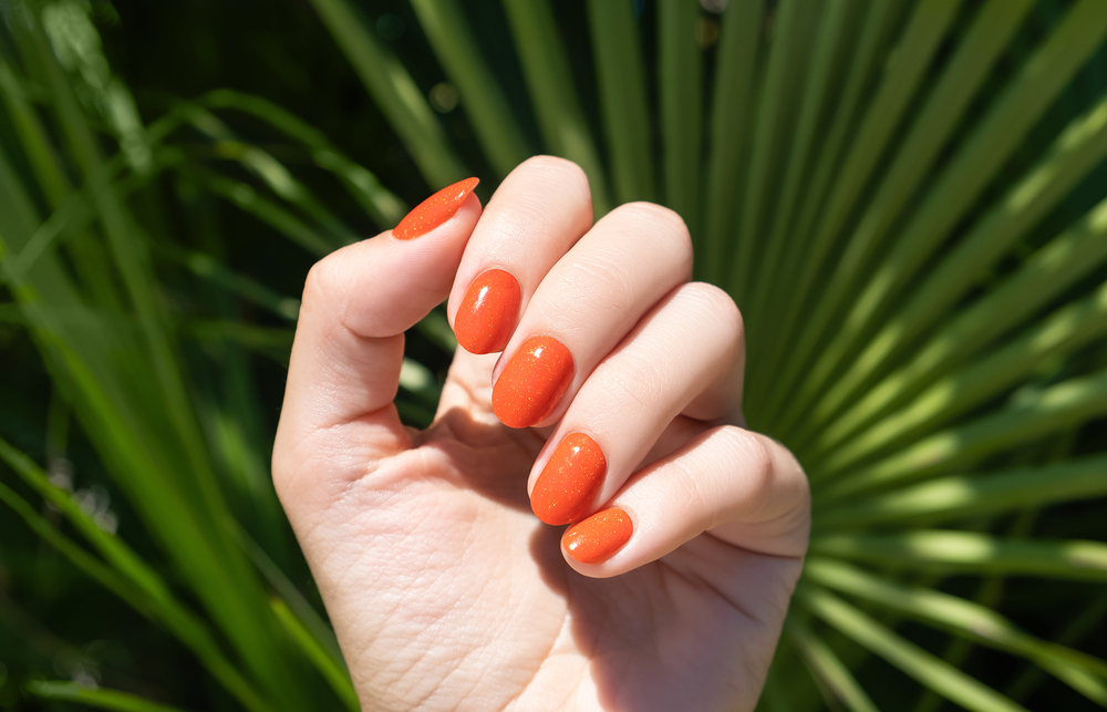 Female,Hand,With,Orange,Nail,Design.,Orange,Nail,Polish,Manicure.