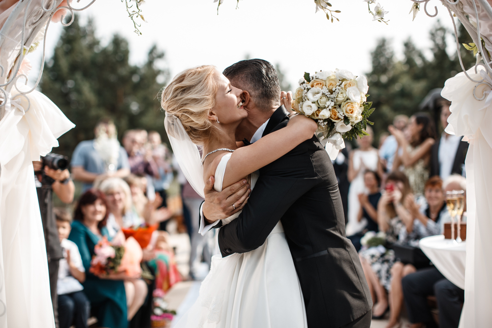 A,Bride,And,A,Groom,Are,Hugging,In,Front,Of