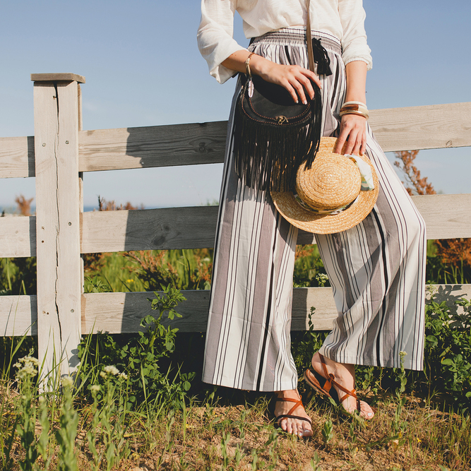 Young,Stylish,Woman,In,Countryside,,Holding,A,Straw,Hat,,Summer,