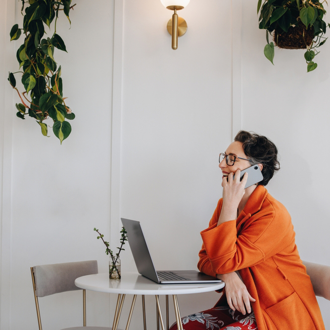 Successful,Business,Woman,Speaking,On,A,Phone,Call,While,Working