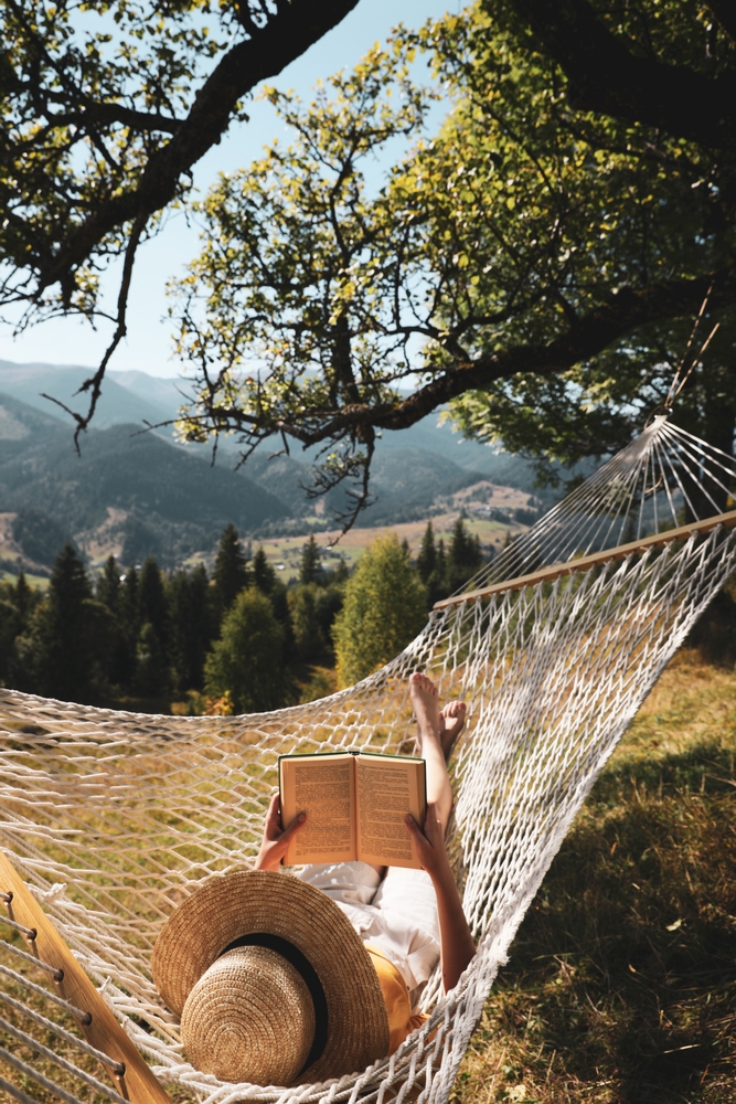 Young,Woman,Reading,Book,In,Hammock,Outdoors,On,Sunny,Day