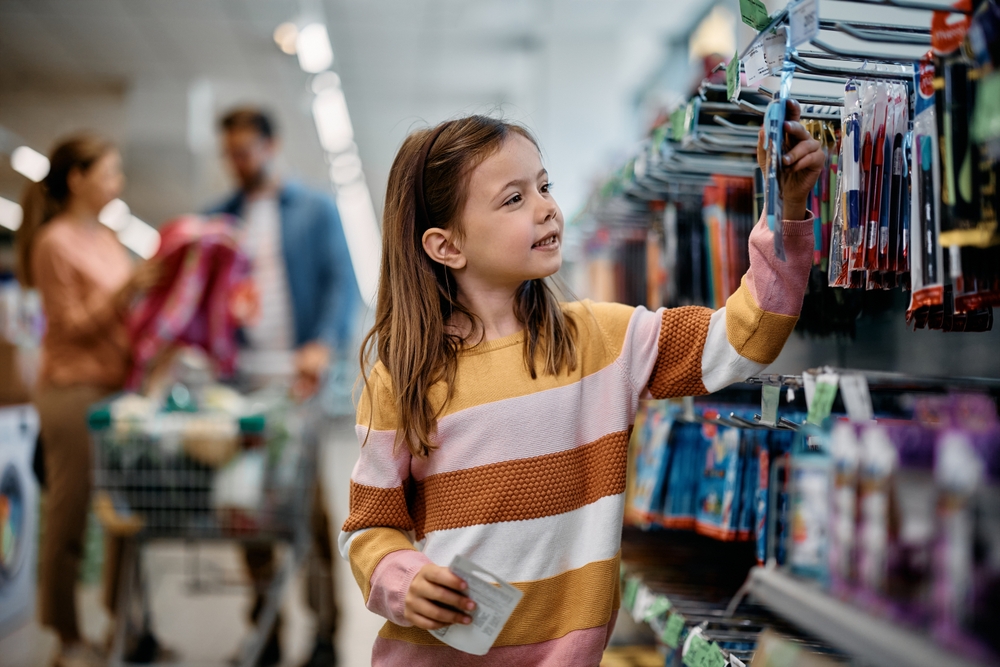 Smiling,Little,Girl,Buying,School,Supplies,While,Being,With,Her