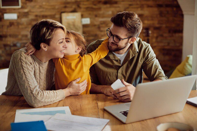 happy-daughter-embracing-kissing-her-working-parents-home