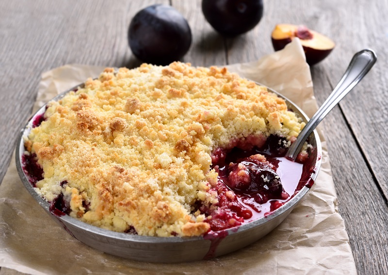 Plum,Crumb,Baking,In,Pan,On,Wooden,Background