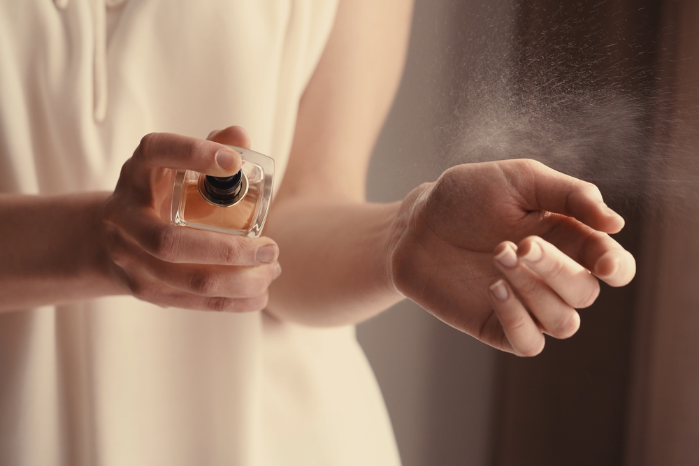 Beautiful,Young,Woman,With,Bottle,Of,Perfume,At,Home,,Closeup