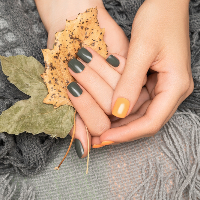 Female,Hands,With,Green,And,Yellow,Autumn,Nail,Design.,Female