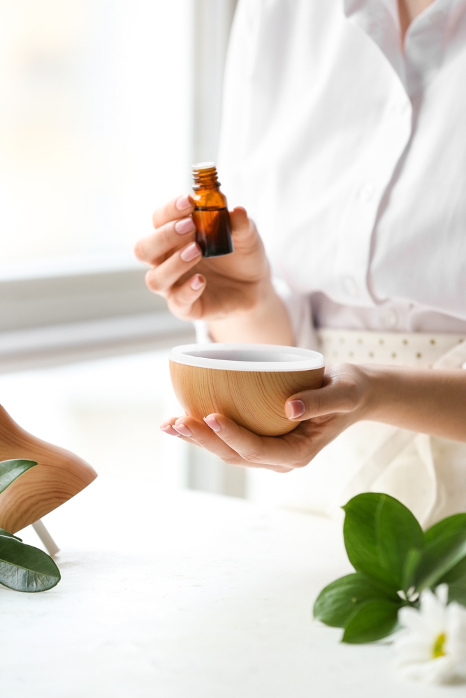 Woman,Adding,Essential,Oil,To,Aroma,Diffuser