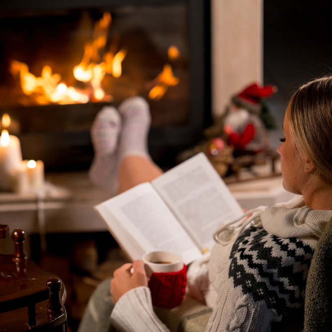 Woman,Is,Sitting,With,Cup,Of,Hot,Drink,And,Book