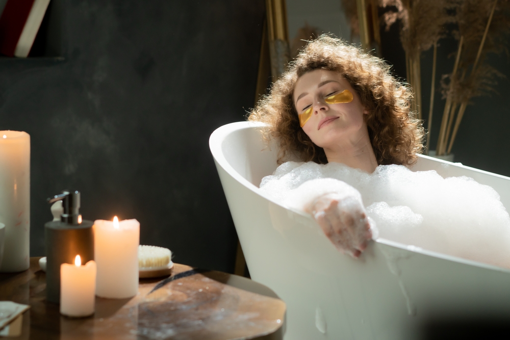 Pleasant,Caucasian,Woman,Puts,On,Eye,Patches,And,Relaxes,In