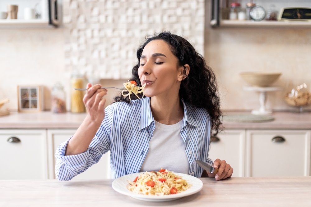 Young,Latin,Woman,Eating,Delicious,Pasta,,Enjoying,Tasty,Homemade,Lunch