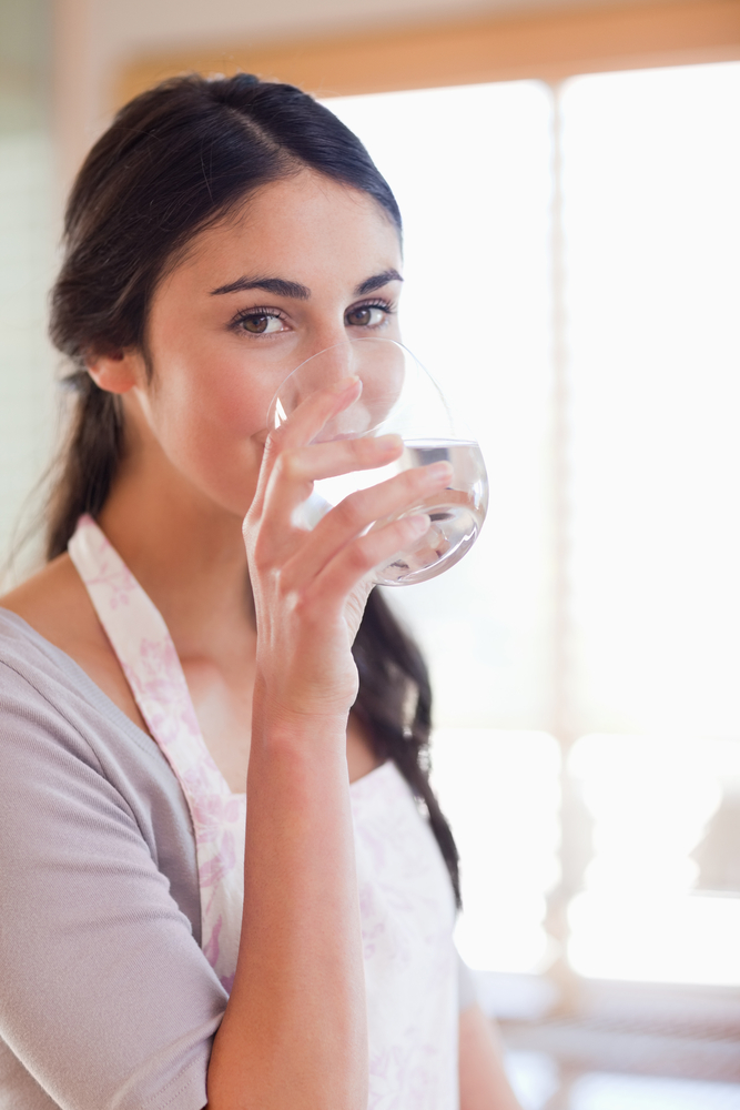 Portrait,Of,A,Beautiful,Woman,Drinking,Water,In,Her,Kitchen