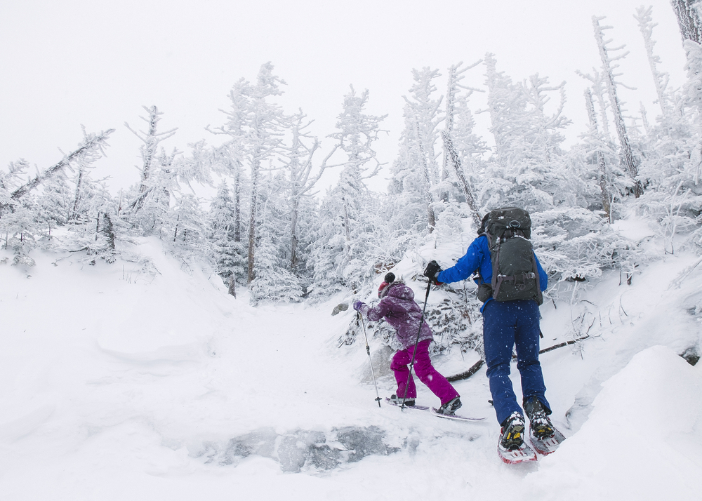 A,Man,And,A,Young,Girl,Snowshoeing,Up,A,Snowy