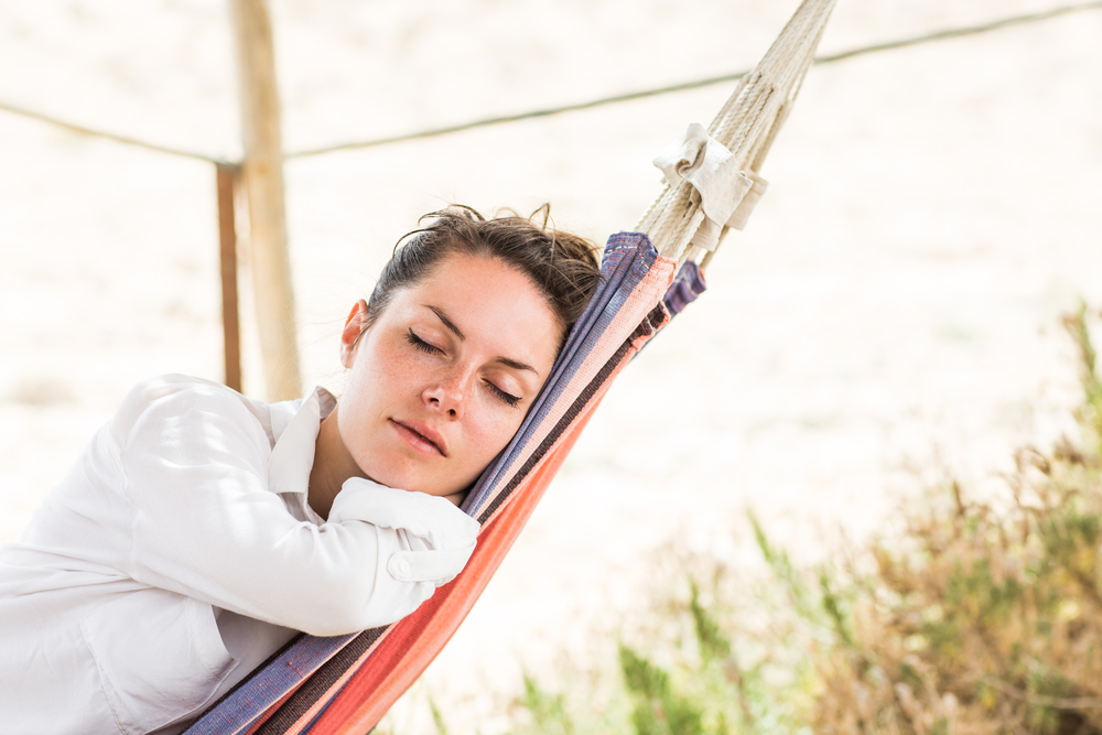 Young,Beautiful,Woman,Sleeping,On,Hammock,In,The,Very,Hot
