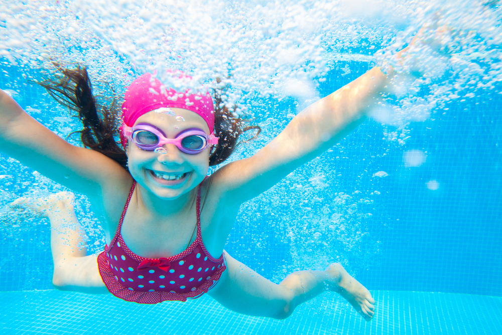 Little,Girl,Deftly,Swim,Underwater,In,Pool