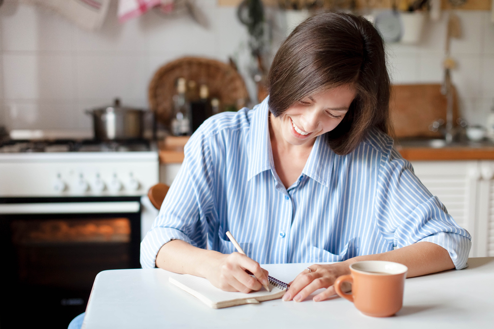 Young,Woman,Writting,Notes,In,Paper,Notebook.,Happy,Girl,Sitting