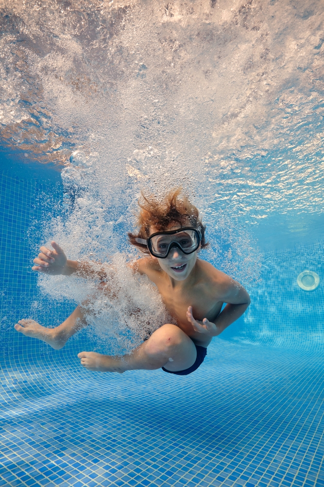 Full,Body,Of,Barefoot,Boy,In,Goggles,Jumping,In,Clear