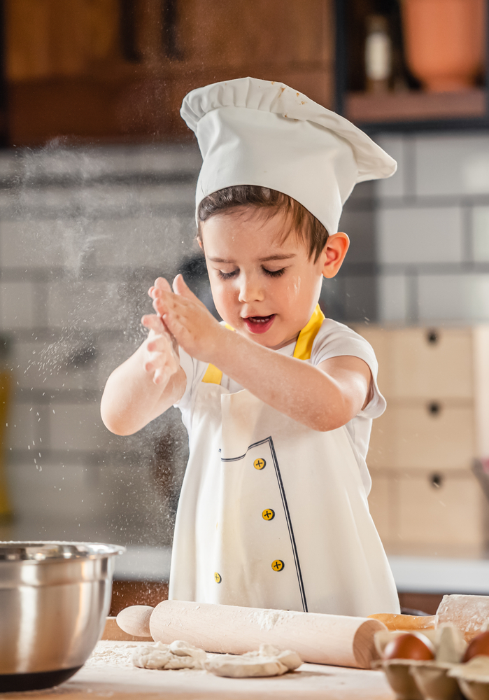 Toddler,Boy,Playing,With,The,Dough,In,The,Kitchen,Dressed