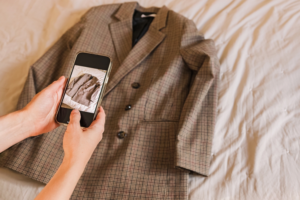 Woman,Taking,Picture,Of,The,Jacket,With,Her,Phone.,Selling