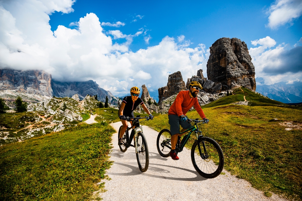 A,Man,And,Woman,Ride,Electric,Mountain,Bikes,In,The