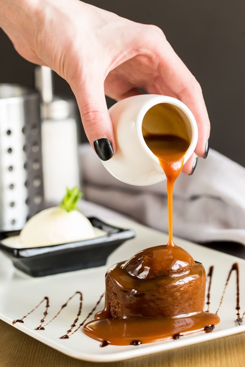 A,Date,Cake,With,Caramel.,A,Man,Pours,Caramel,On