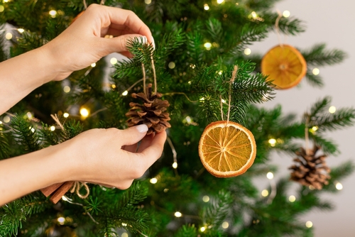 Female,Hands,Hanging,Handmade,Decoration,On,Christmas,Tree.,Sustainable,Christmas,